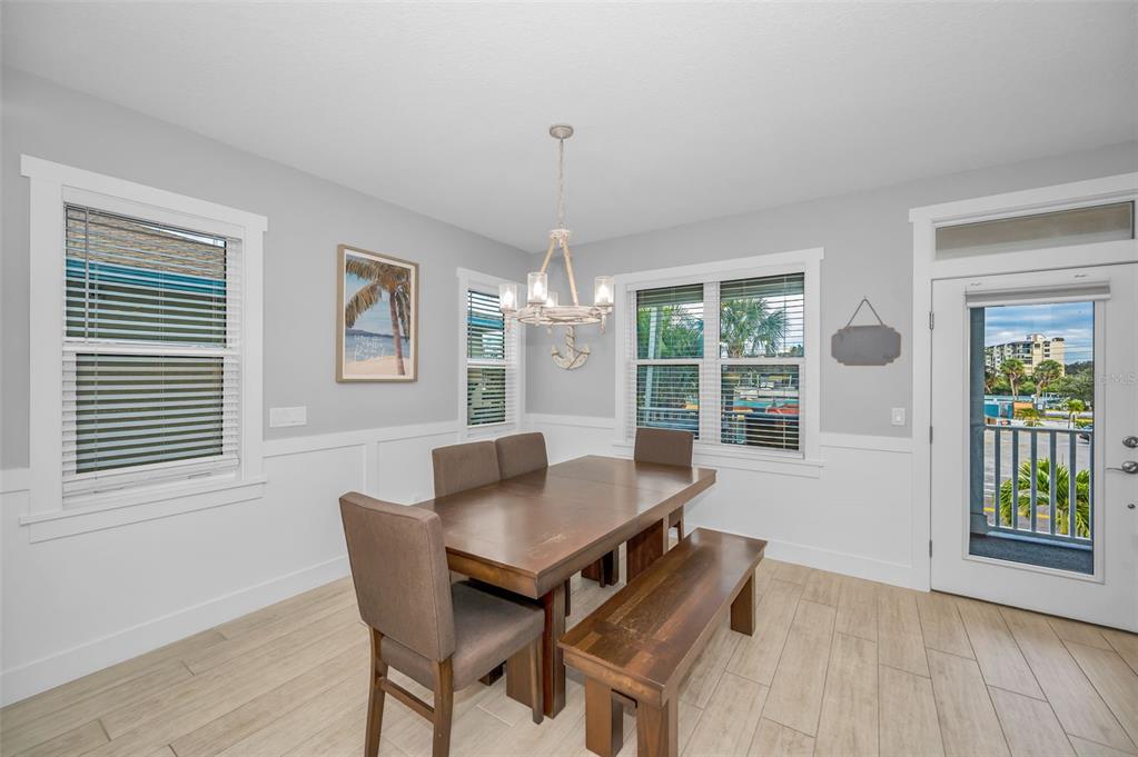 204 Gulf Boulevard Indian Rocks Beach, FL 33785 - Photo 23 of 72 a view of a dining room with furniture window and wooden floor