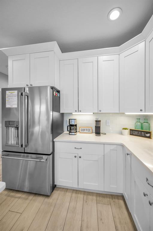 204 Gulf Boulevard Indian Rocks Beach, FL 33785 - Photo 29 of 72 a kitchen with stainless steel appliances granite countertop a refrigerator sink and cabinets