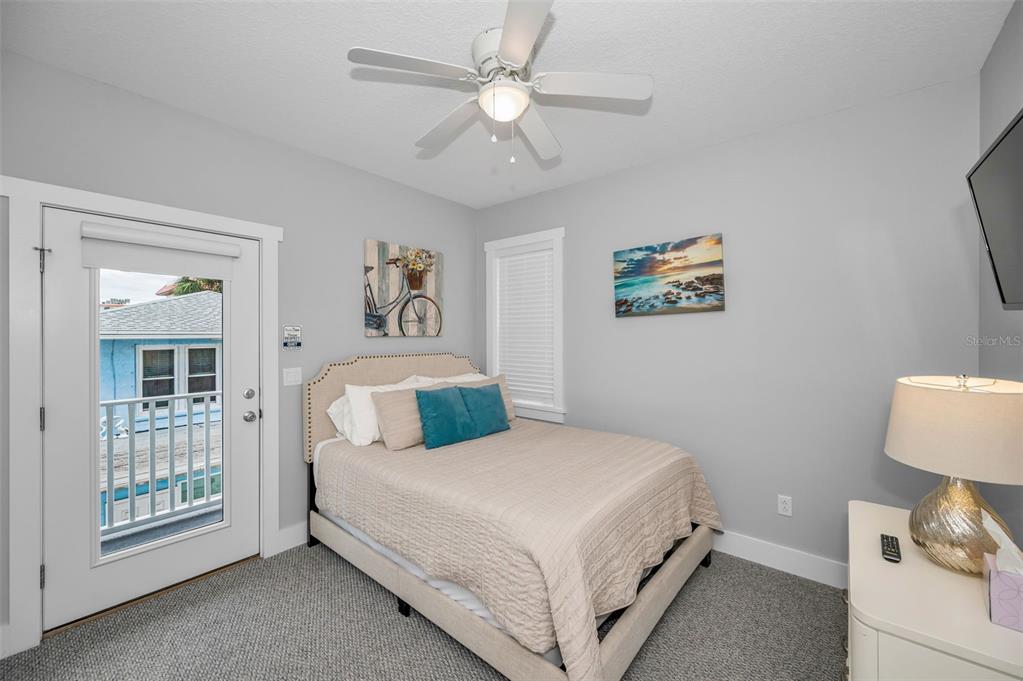 204 Gulf Boulevard Indian Rocks Beach, FL 33785 - Photo 34 of 72 a bedroom with a bed and a chandelier