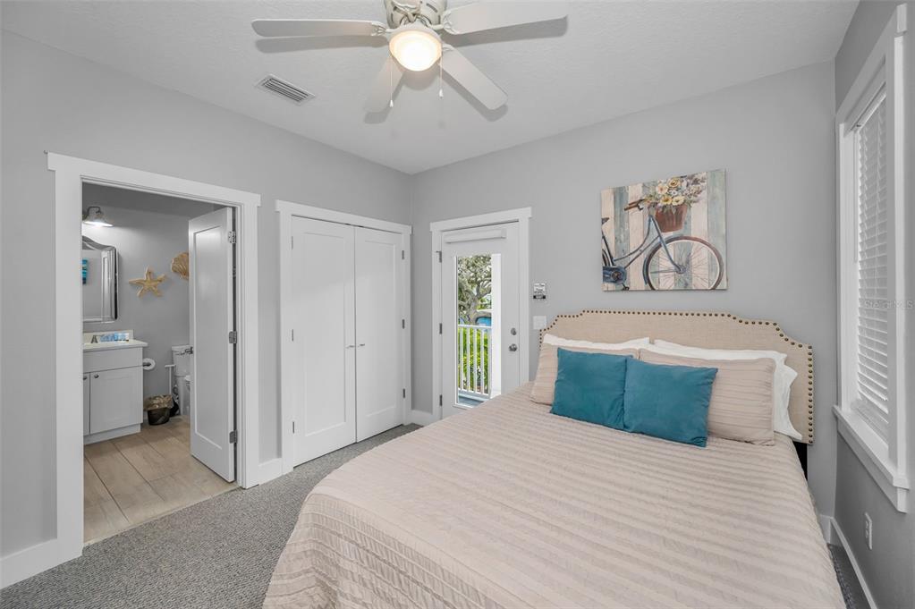 204 Gulf Boulevard Indian Rocks Beach, FL 33785 - Photo 35 of 72 a bedroom with a large bed and a chandelier