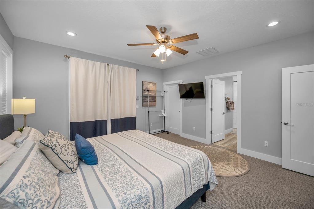 204 Gulf Boulevard Indian Rocks Beach, FL 33785 - Photo 44 of 72 a bedroom with a bed and a chandelier