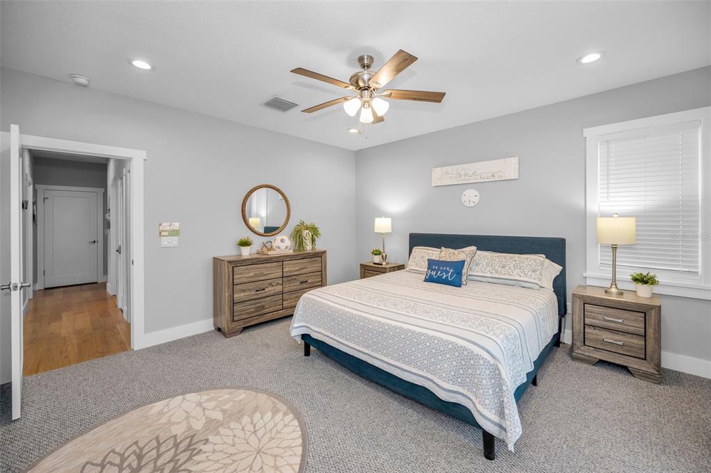 204 Gulf Boulevard Indian Rocks Beach, FL 33785 - Photo 46 of 72 a bedroom with a bed and a chandelier