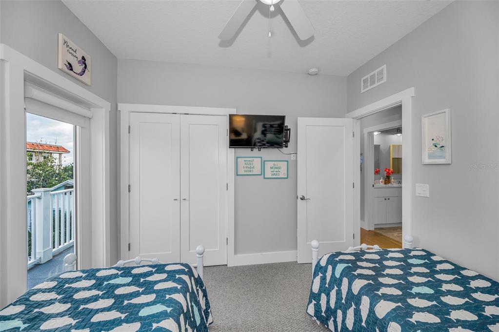 204 Gulf Boulevard Indian Rocks Beach, FL 33785 - Photo 49 of 72 a bedroom with a bed and flat screen tv