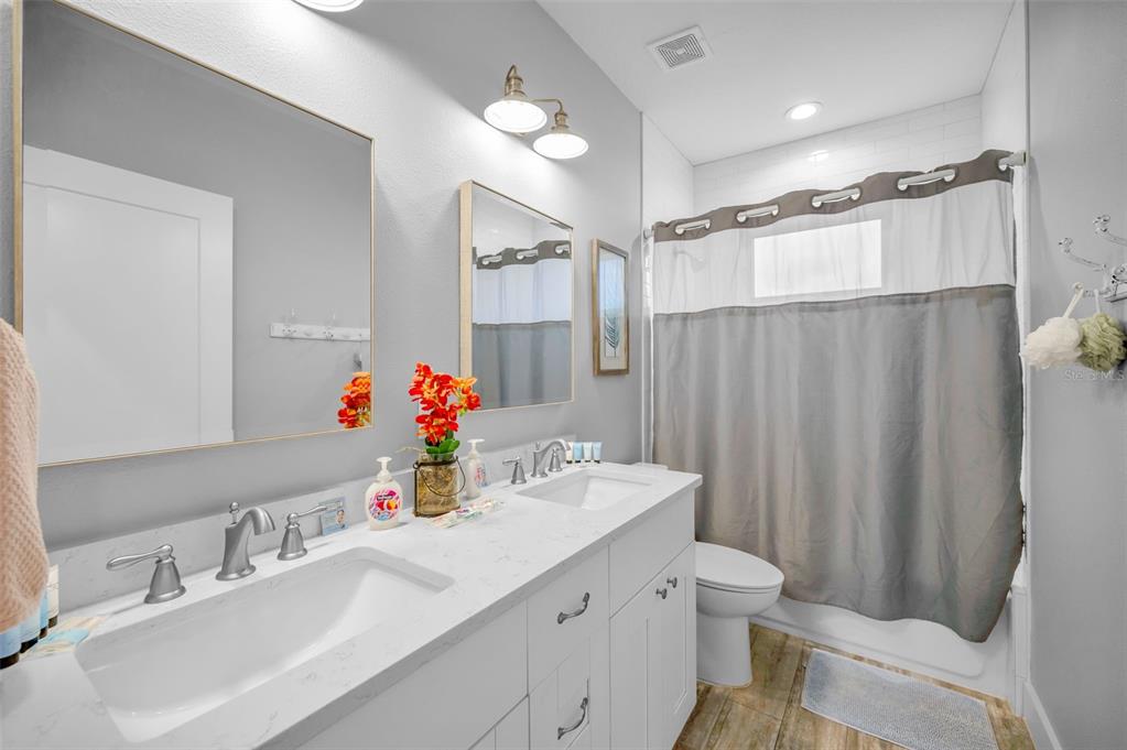 204 Gulf Boulevard Indian Rocks Beach, FL 33785 - Photo 50 of 72 a bathroom with a sink toilet double vanity and shower