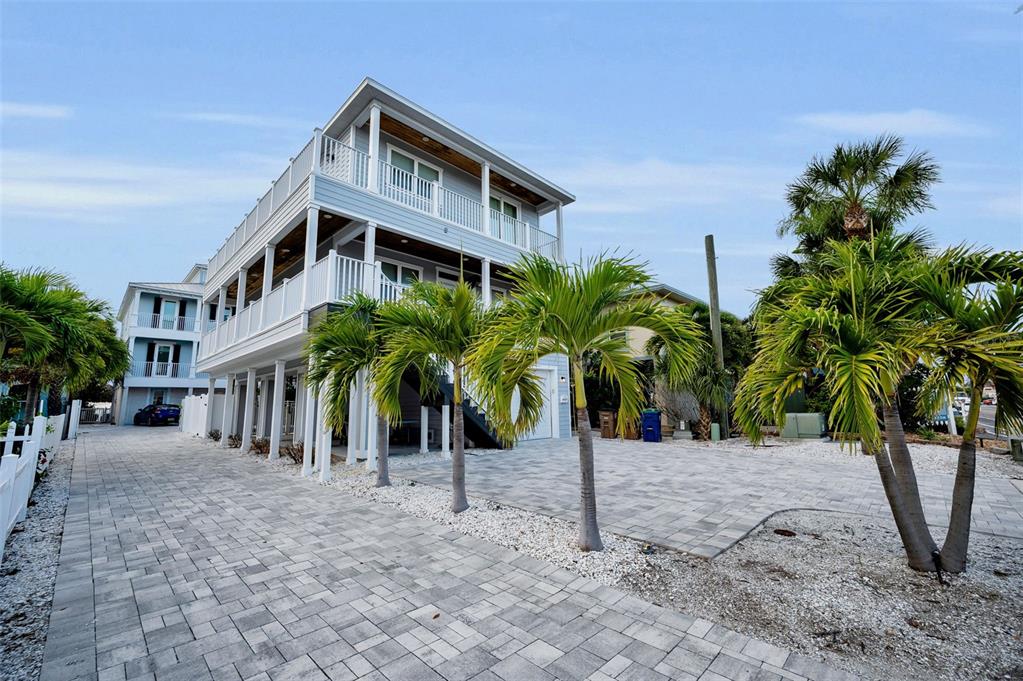 204 Gulf Boulevard Indian Rocks Beach, FL 33785 - Photo 5 of 72 a front view of multiple house with small garden