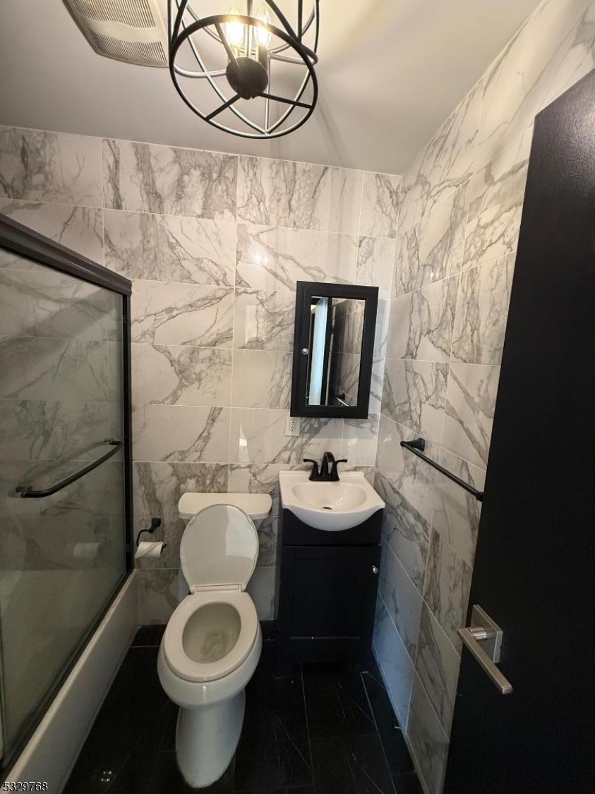 182 Ferry Street, Unit 2B Newark, NJ 07105 - Photo 11 of 16 a bathroom with a toilet sink and mirror