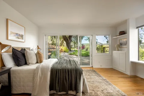 a bedroom with a bed and a large window