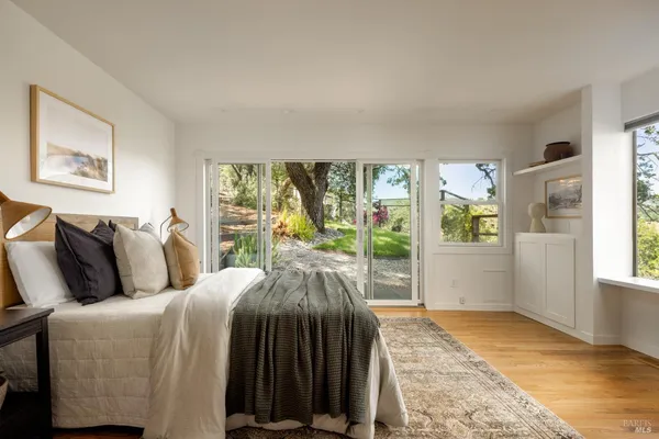 a bedroom with a bed and a large window
