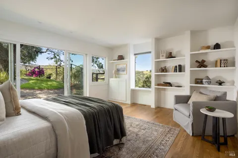 a bedroom with a bed a couch and dresser