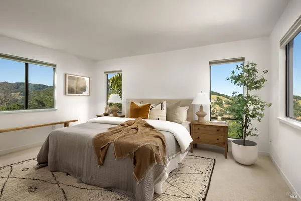 a bed sitting in a bedroom next to a window