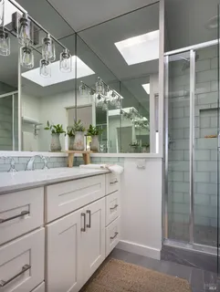 a bathroom with a double vanity sink and a mirror