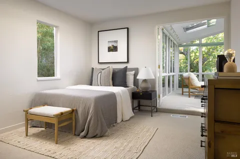 a bedroom with a bed and a night stand