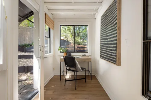 a view of a dining room with furniture and a window