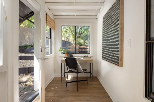 a view of a dining room with furniture and a window