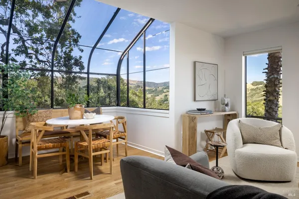 a view of a dining room with furniture window and outside view