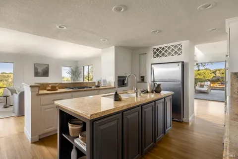 a kitchen with granite countertop a sink and cabinets