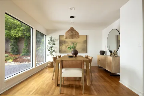 a dining room with furniture and window