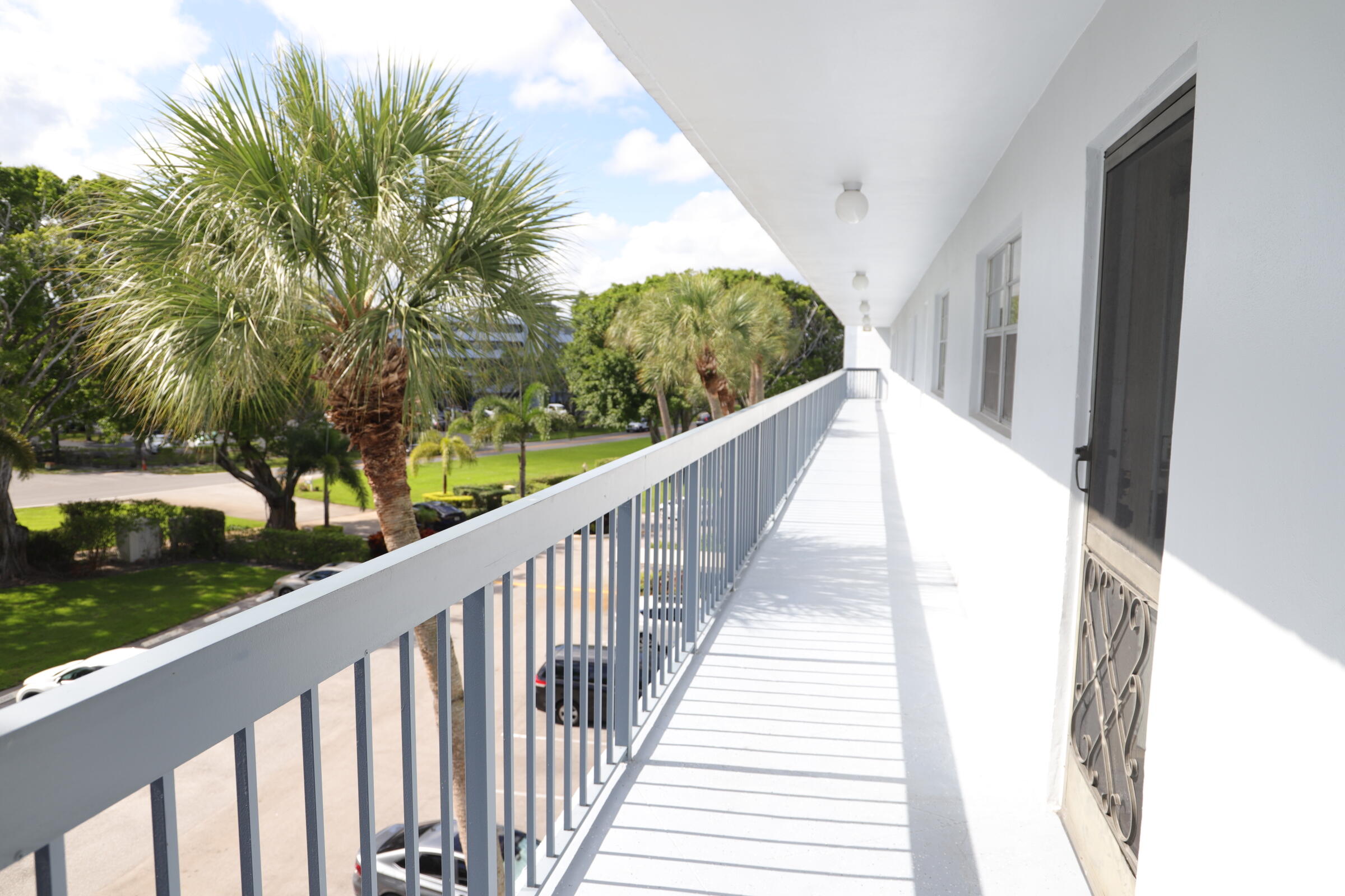 6400 Northwest 2nd Avenue, Unit 423 Boca Raton, FL 33487 - Photo 18 of 19 a view of a balcony with wooden floor
