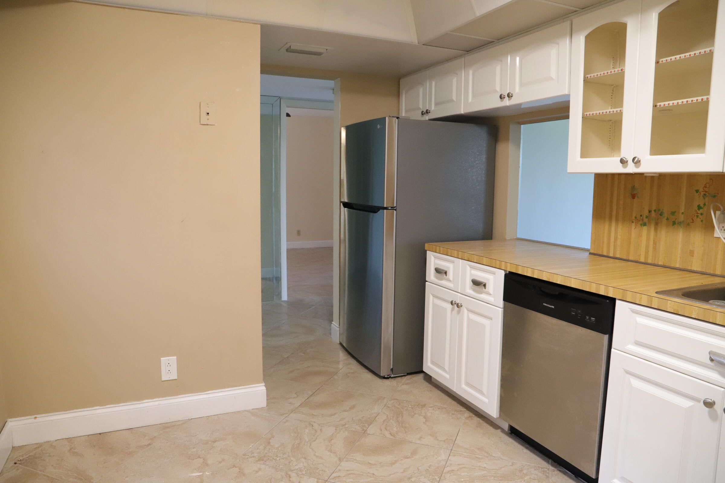 6400 Northwest 2nd Avenue, Unit 423 Boca Raton, FL 33487 - Photo 2 of 19 a kitchen with stainless steel appliances a refrigerator and a stove