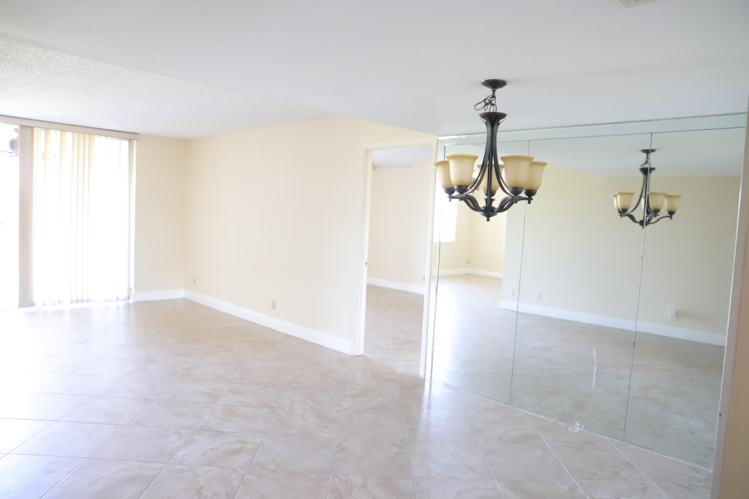 6400 Northwest 2nd Avenue, Unit 423 Boca Raton, FL 33487 - Photo 5 of 19 a view of a hallway with a chandelier