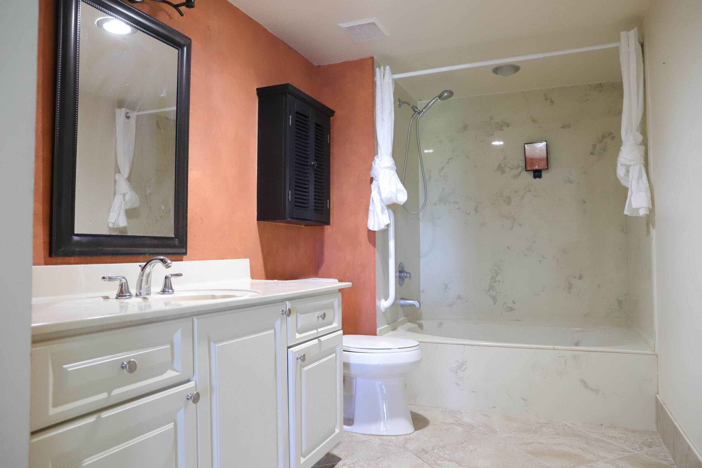 6400 Northwest 2nd Avenue, Unit 423 Boca Raton, FL 33487 - Photo 10 of 19 a bathroom with a sink a toilet and shower