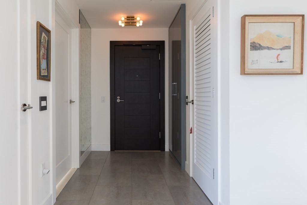 32 Traveler Street, Unit 304 Boston, MA 02118 - Photo 23 of 35 a view of a hallway with paintings on the wall