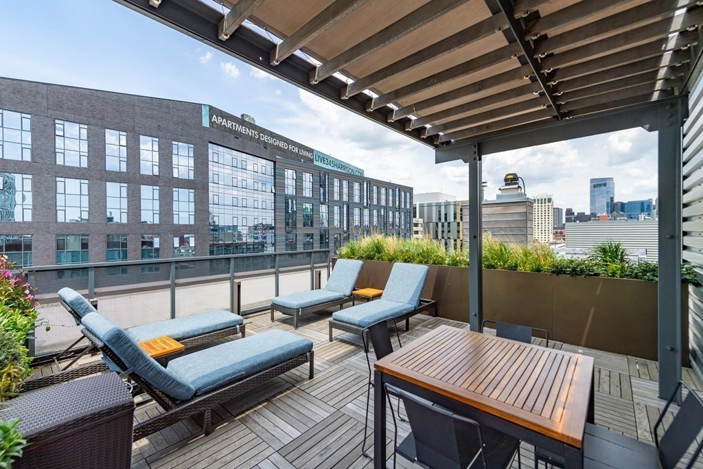 32 Traveler Street, Unit 304 Boston, MA 02118 - Photo 29 of 35 a roof deck with a table and chairs