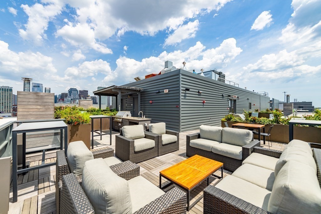 32 Traveler Street, Unit 304 Boston, MA 02118 - Photo 31 of 35 a view of a patio with couches chairs and a table