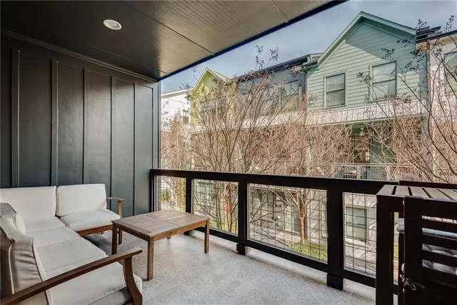a balcony with furniture and a window