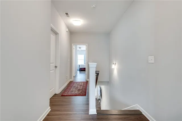 a view of a room with wooden floor