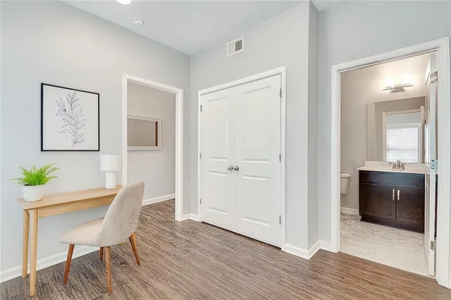 a workspace room with furniture and wooden floor