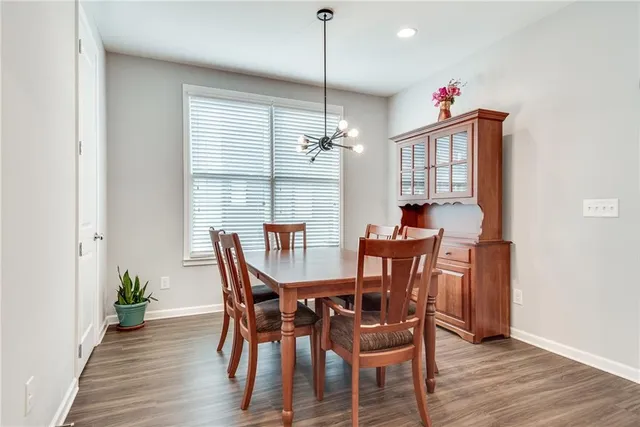 a dining room with furniture window and wooden floor