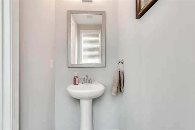 a bathroom with a sink and mirror