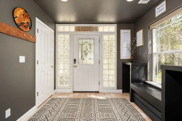 a living room with furniture large window and flat screen tv