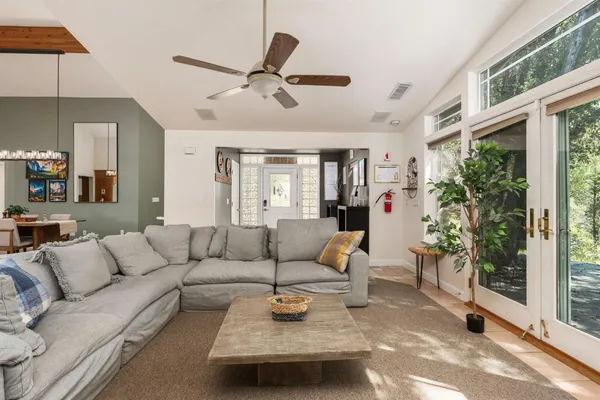 a living room with furniture a dining table and chairs