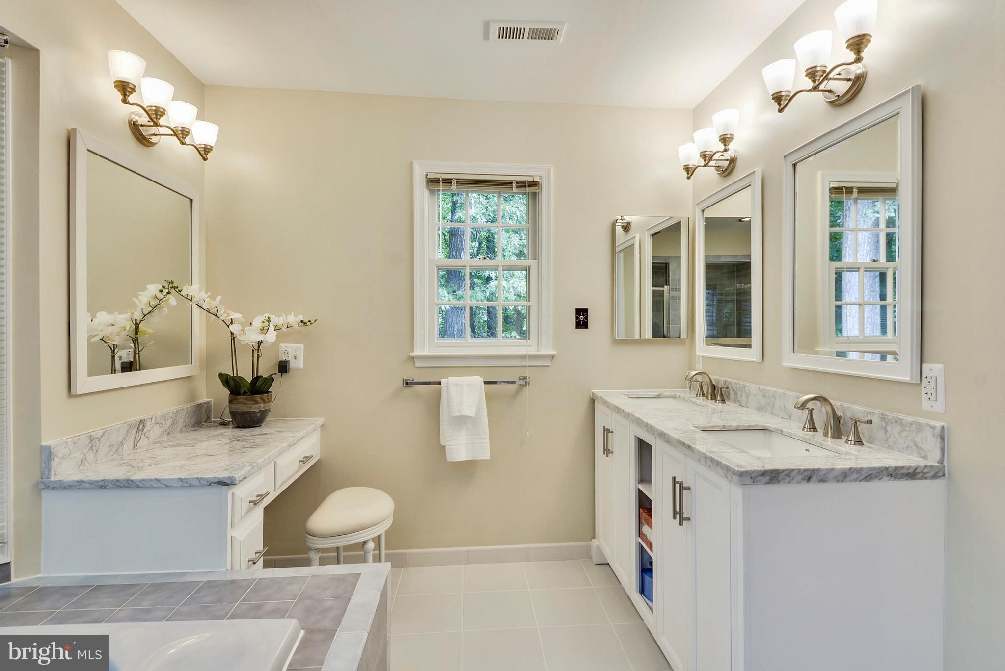 6505 Deidre Terrace McLean, VA 22101 - Photo 18 of 30 a bathroom with a granite countertop sink and a mirror