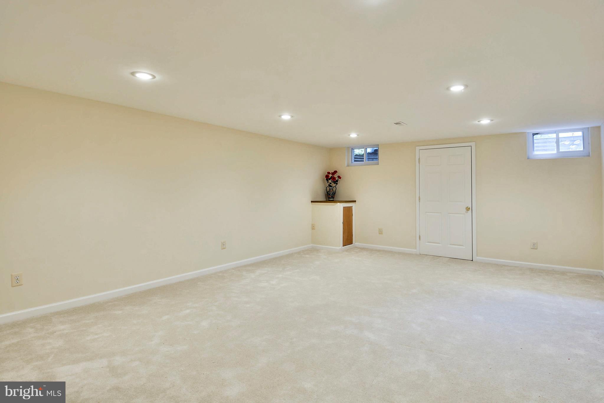 6505 Deidre Terrace McLean, VA 22101 - Photo 24 of 30 an empty room with a projector and white walls