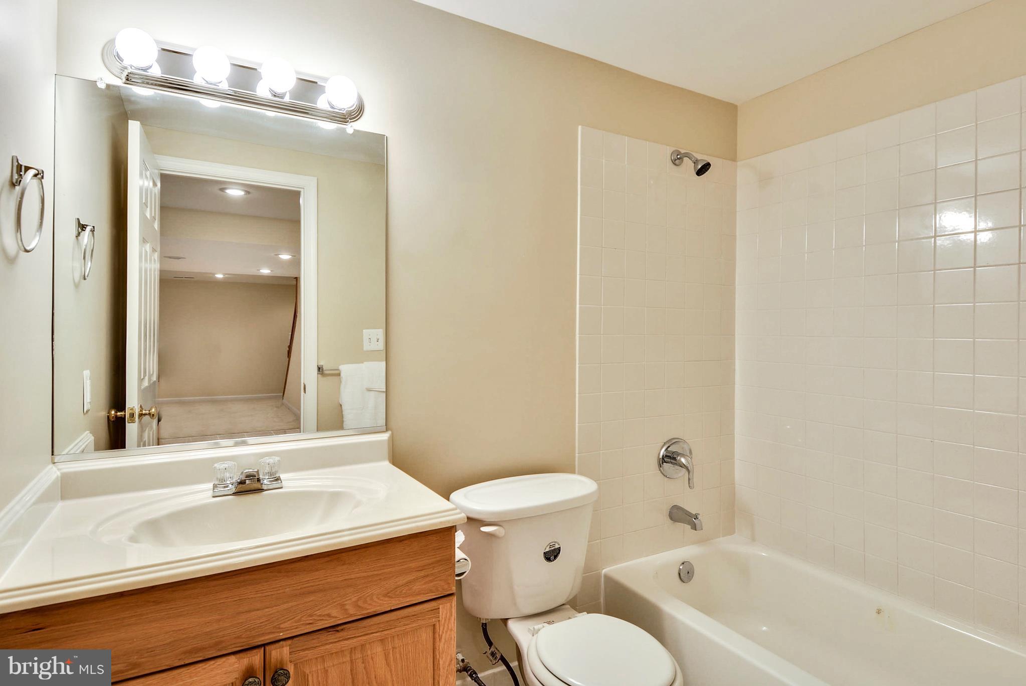 6505 Deidre Terrace McLean, VA 22101 - Photo 26 of 30 a bathroom with a sink toilet vanity and shower
