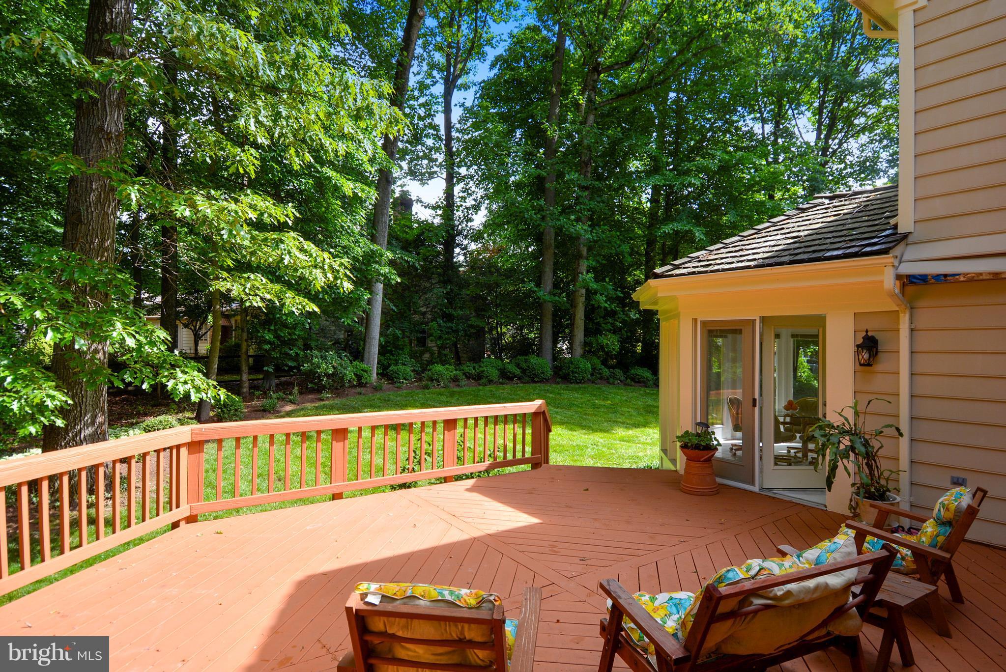 6505 Deidre Terrace McLean, VA 22101 - Photo 29 of 30 a view of a patio with table and chairs potted plants with wooden floor and fence