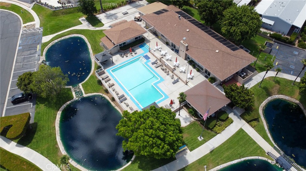 an aerial view of a house with a swimming pool and outdoor seating
