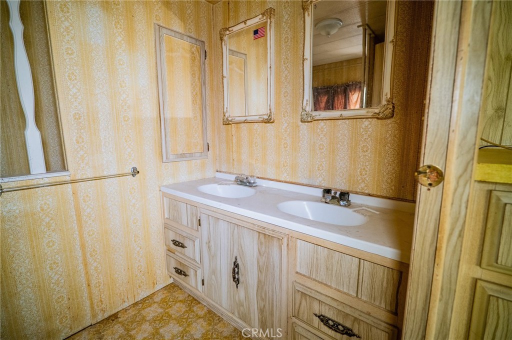 1439 Ridgemont Way Corona, CA 92882 - Photo 11 of 17 a bathroom with a granite countertop sink and a mirror