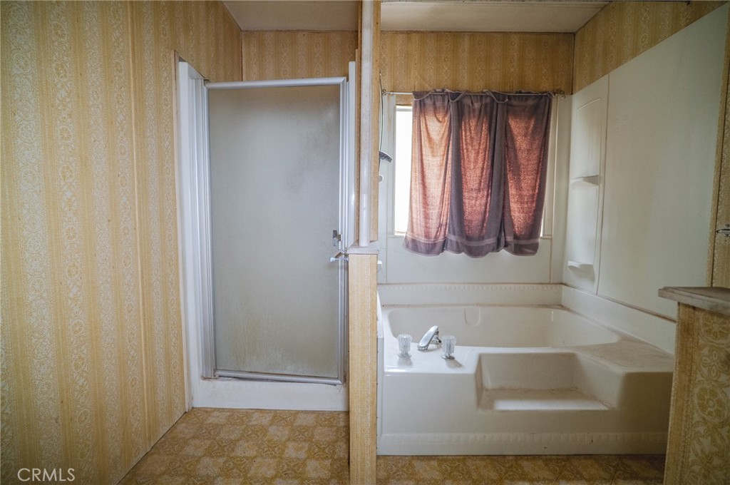 1439 Ridgemont Way Corona, CA 92882 - Photo 13 of 17 a bathroom with a tub and shower