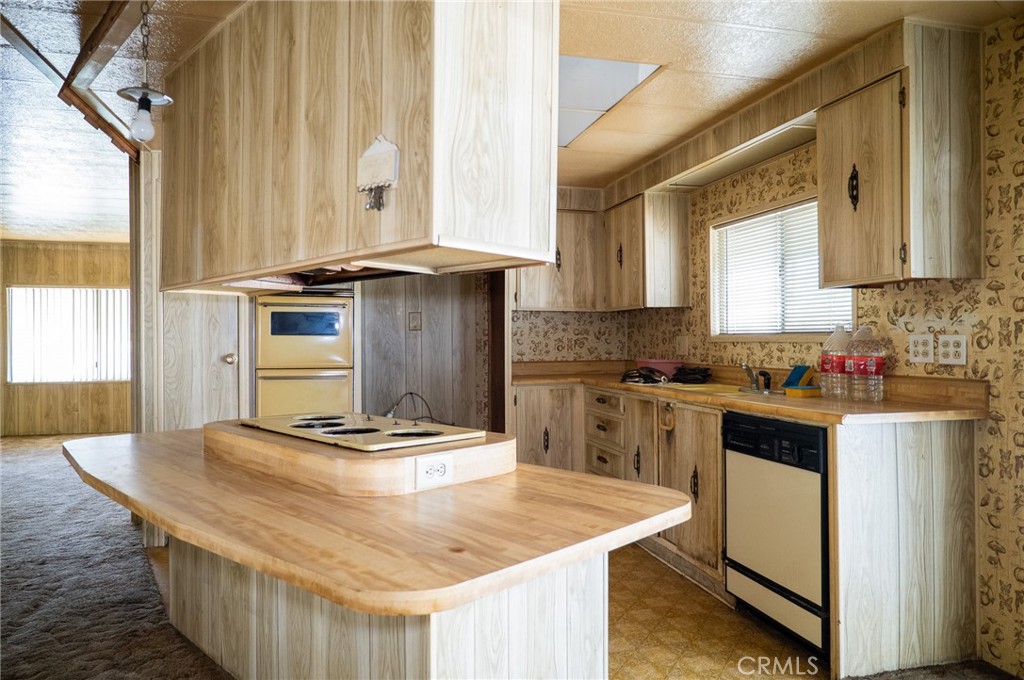 1439 Ridgemont Way Corona, CA 92882 - Photo 7 of 17 a kitchen with kitchen island granite countertop a sink a stove and refrigerator