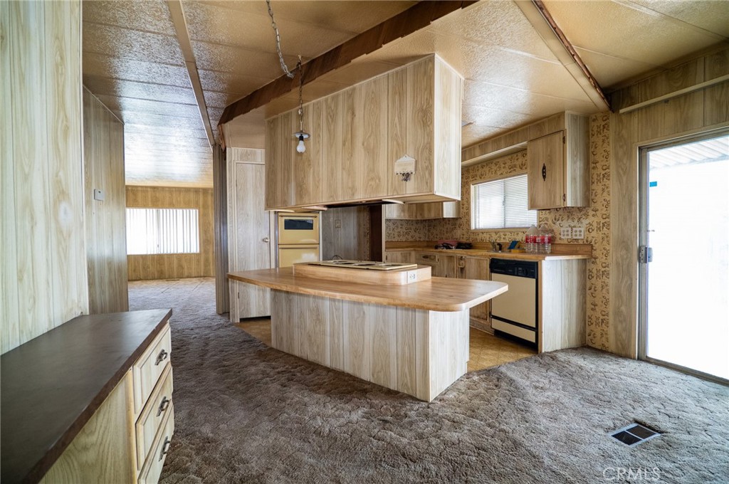 1439 Ridgemont Way Corona, CA 92882 - Photo 8 of 17 a kitchen with granite countertop a sink a counter top space and stainless steel appliances