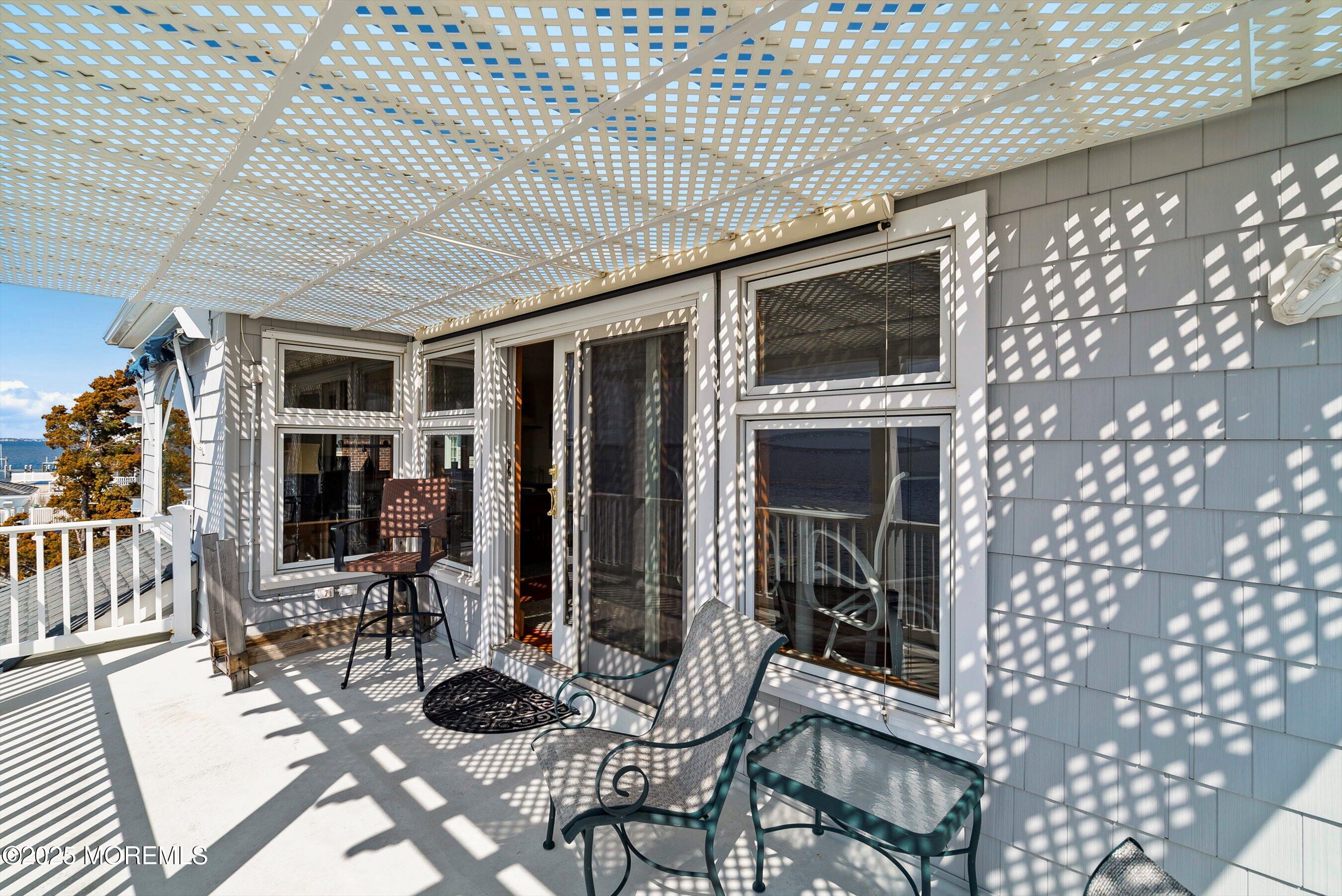133 Pershing Boulevard Lavallette, NJ 08735 - Photo 37 of 86 a living room with furniture a flat screen tv and outdoor seating