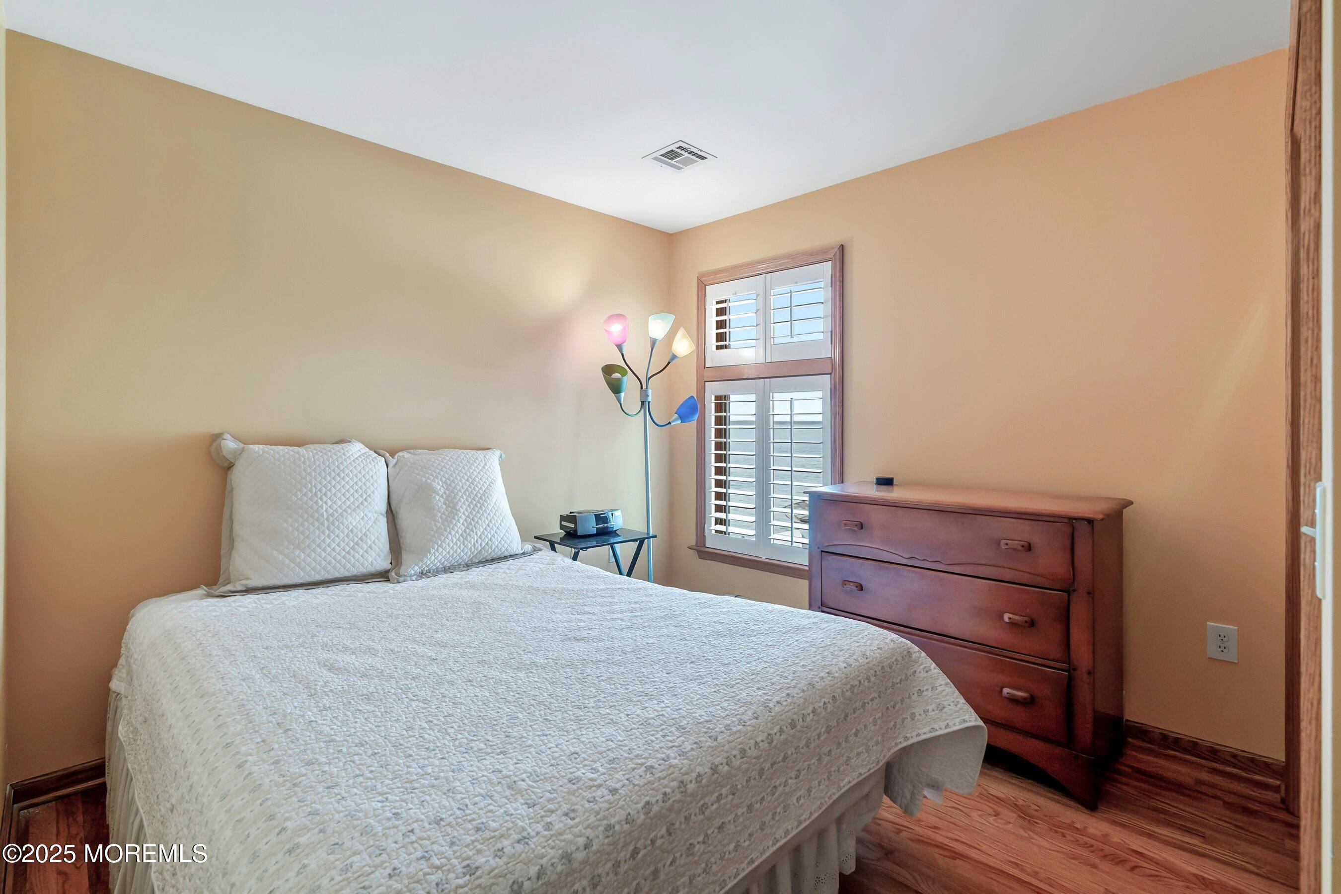 133 Pershing Boulevard Lavallette, NJ 08735 - Photo 53 of 86 a bedroom with a bed and a window