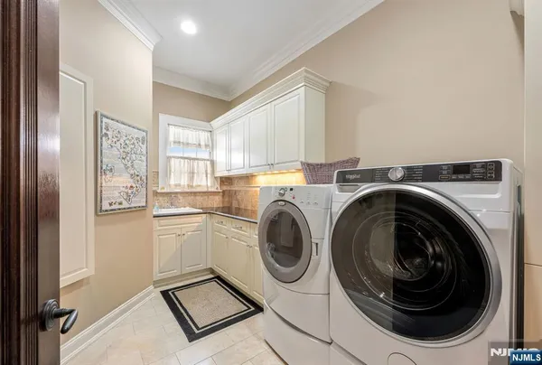 a utility room with sink dryer and washer