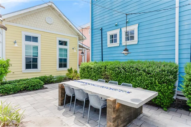 a view of a patio with couches table and chairs and potted plants
