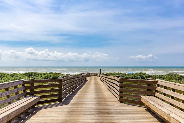 a sign that is sitting in front of flowers