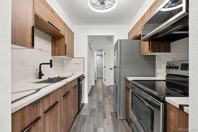 a kitchen that has a sink and a stove